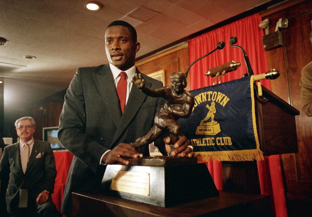 Notre Dame's wide receiver and kick return specialist Tim Brown poses with the Heisman Trophy after being named 1987's best college football player at New York's Downtown Athletic Club, in this Dec. 5, 1987 file photo.  (AP Photo/Ron Frehm)